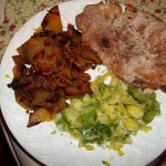 Fried rutabaga with broiled pork chop and Brussells sprout slaw